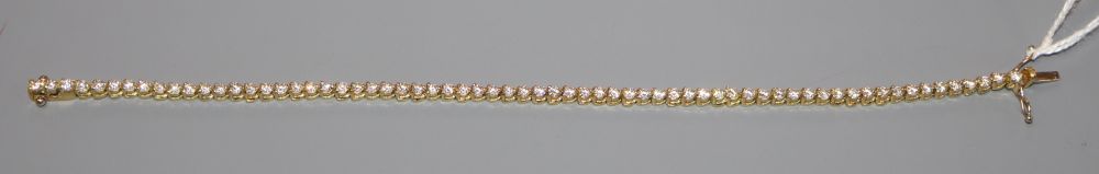 A modern 750 yellow metal and diamond set line bracelet, 18.5cm, gross 10.6 grams.
